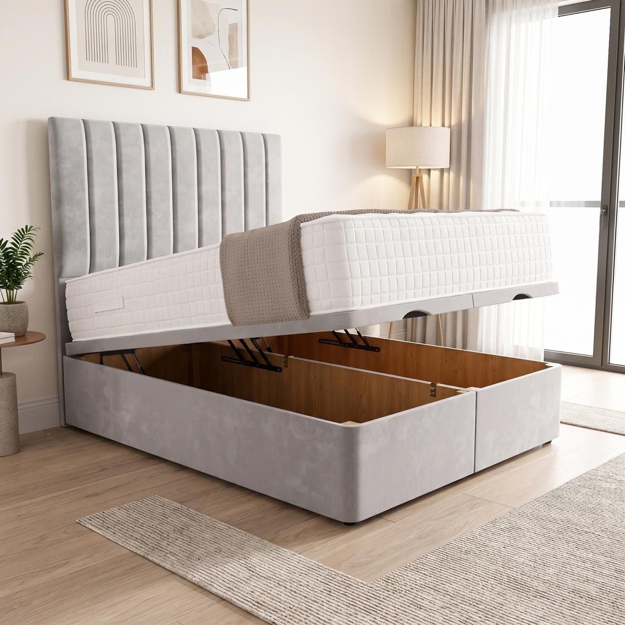 Paris ottoman storage bed in light grey with a vertical fluted panel headboard with winged sides, base raised to show the full-length storage
